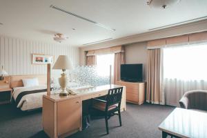 Una cama o camas en una habitación de Numazu River Side Hotel