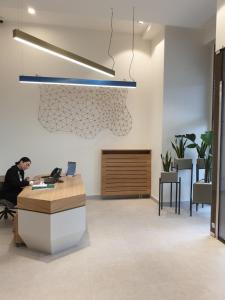 an office with a man sitting at a desk with a laptop at GIGI Apartment in Belgrade