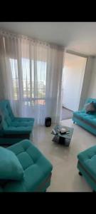a living room with two blue couches and a table at Apartamento en Condomio Peñazul La Aldea en Ricaurte - Girardot in Ricaurte