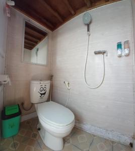 a bathroom with a toilet and a shower at Boat Open Trip Komodo 3Days 2 Nigths in Labuan Bajo
