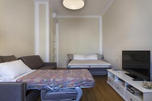 ein kleines Wohnzimmer mit einem Sofa und einem TV in der Unterkunft Apartment Papiniano 38 in Mailand