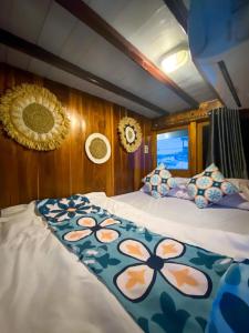a bedroom with two beds on a boat at Boat Open Trip Komodo 3Days 2 Nigths in Labuan Bajo