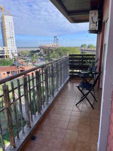 a balcony with a table and a view of the ocean at Dpto Costanera in Corrientes