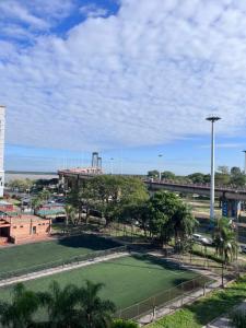 a park with a large green field in a city at Dpto Costanera in Corrientes
