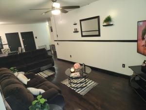 a living room with a couch and a ceiling fan at Spacious 3br, 2b in Brooklyn