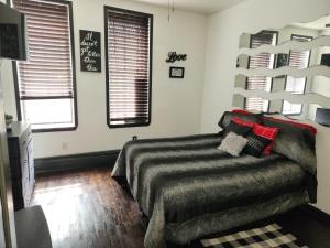 a bedroom with a bed and two windows at Spacious 3br, 2b in Brooklyn