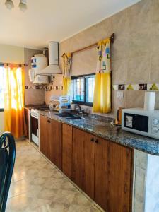 a kitchen with a sink and a microwave on a counter at San Rafael in San Rafael