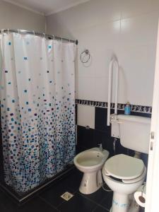 a bathroom with a toilet and a shower curtain at San Rafael in San Rafael