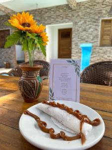 a piece of food on a plate on a table at Villa Dom Felippe in Jericoacoara