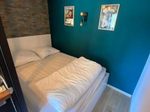 małe łóżko w pokoju z niebieską ścianą w obiekcie Studio Châtel, 1 pièce, 4 personnes - FR-1-693-97 w mieście Châtel