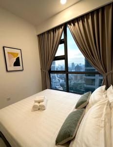 a bedroom with a bed with a large window at The Robertson 1R1B/High flr-cosy room/ Bukit-bint in Kuala Lumpur