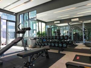 a gym with a lot of exercise equipment and windows at A401-Silk Condo Aonang, Sea view - 5 mins to beach in Krabi town