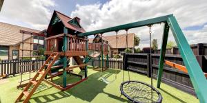 a playground with a swing and a swing at Arista of Rotorua in Rotorua