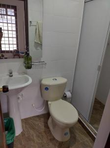 a bathroom with a toilet and a sink at Casa Hotel Palermo 49 in Bogotá
