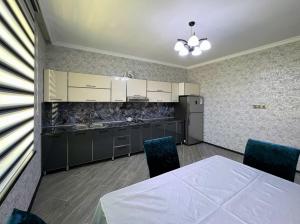 a kitchen with a table and chairs in a room at Gabala villa in the center in Gabala