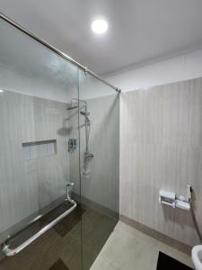 a bathroom with a shower with a glass door at Kulem Gempol in Bandung