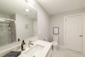 a white bathroom with a sink and a toilet at Suite Dreams 2BR Parking Yale New Haven Lawn Club in New Haven