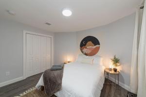 a bedroom with a large white bed with a round headboard at Suite Dreams 2BR Parking Yale New Haven Lawn Club in New Haven