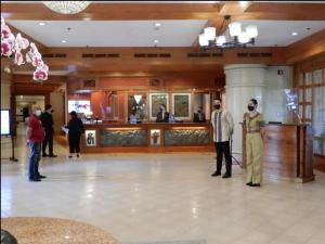 a group of people standing in a lobby at The Forest Lodge at Camp John Hay privately owned unit with parking 265 in Baguio