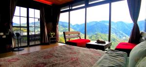 a bedroom with a large window with a view of mountains at Villa Relax in Ren'ai