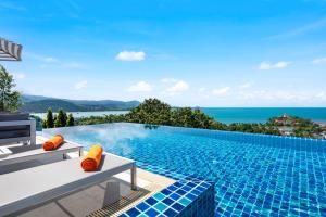 a swimming pool with a view of the ocean at Unique Boutique Residences in Bang Rak Beach