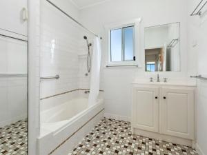 a white bathroom with a tub and a sink at The Point - Panoramic Views over Pottsville Creek in Pottsville