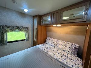 a bedroom with a bed in an rv at Salmon River RV camping in Mountain Grove