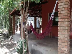 a porch with hammocks hanging from a building at Camping Guapira in Vale do Capao