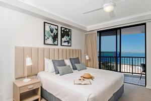 a bedroom with a bed with a view of the ocean at Mantra Coolangatta Beach in Gold Coast