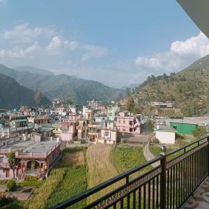 a view of a town with mountains in the background at An Himalayan View by StayApart in Barkot
