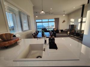 a kitchen with a sink and a living room at Church Street Charmer in Riverton