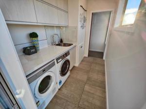 a kitchen with a washing machine and a sink at Church Street Charmer in Riverton