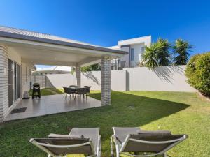 a patio with chairs and a table in a yard at Salty Pause at Bondi House - Pet Friendly! in Kingscliff