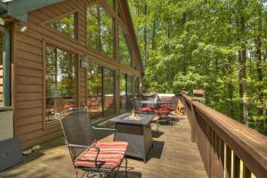 a screened in porch with chairs and a table on a deck at Wind Rush in Ellijay