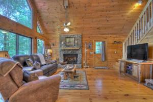 a living room with a couch and a fireplace at Wind Rush in Ellijay