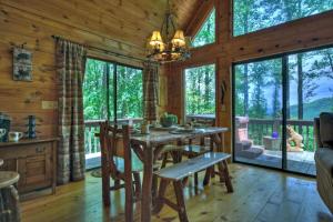 a dining room with a table and chairs in a cabin at Wind Rush in Ellijay