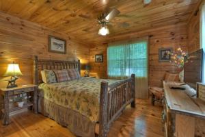 a bedroom with a bed and a ceiling fan at Wind Rush in Ellijay