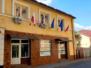 a building with flags on the side of it at Мандри Хостел in Uzhhorod