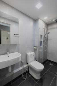 a bathroom with a toilet and a sink and a shower at HayBay Jesselton Quay Deluxe Seaview Suite 海景观 in Kota Kinabalu