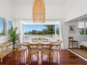a dining room with a table and chairs at Oceanfront Beach House On Marine Parade in Kingscliff