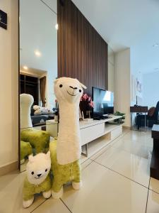 a large stuffed llama standing in a living room at Mansion One by PerfectSweetHome in George Town