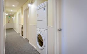 a washer and dryer in a hallway of a room at Ocean's Edge - Anchor Pier Lodge in Newport