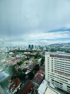 a city view of a city with a tall building at Mansion One l 4pax Studio A l Cityview l Gleneagle l by PerfectSweetHome in George Town