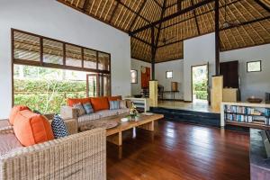 uma sala de estar com um sofá e uma mesa em Villa Sasoon, 100 mt to Beach em Candidasa