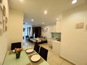 a kitchen and a living room with a table and chairs at Mansion One l 4pax Studio A l Cityview l Gleneagle l by PerfectSweetHome in George Town +27 photos