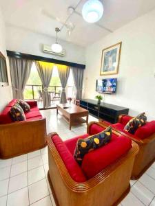 a living room with two couches and a table at Apartment by the Beach Port Dickson - Seaview in Port Dickson