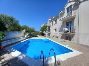 a swimming pool in front of a house at 25 King's Landing in Supetar in Supetar