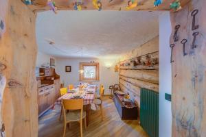 a kitchen and dining room with a table and chairs at Chalet Lidia Ski in-Ski out 50m - Happy Rentals in Livigno