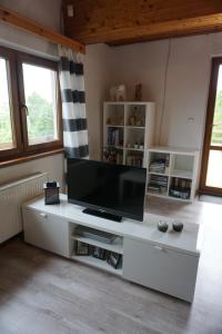 a living room with a large flat screen tv at Chata Žár in Žár