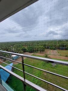 a view from a train window of a farm at Kumars @udupi in Udupi